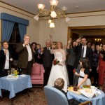 Wedding party and guests making a champagne toast