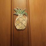 leaded glass pineapple on bedroom door, the symbol of hospitality